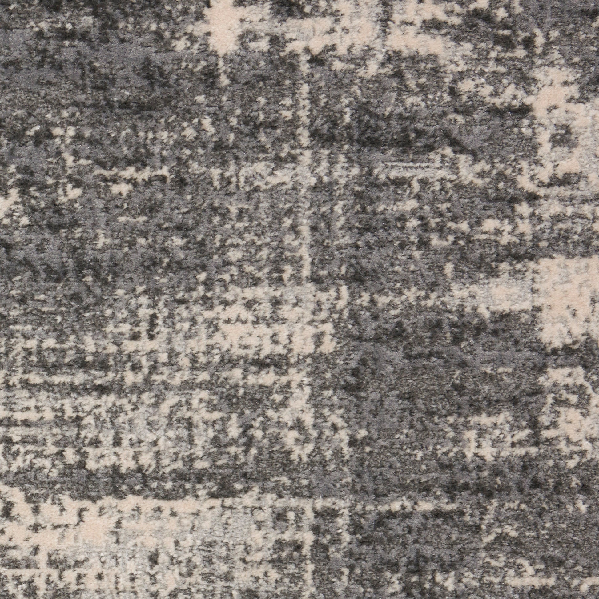 Grey and beige distressed area rug with an abstract, patchy geometric pattern and soft, plush texture.