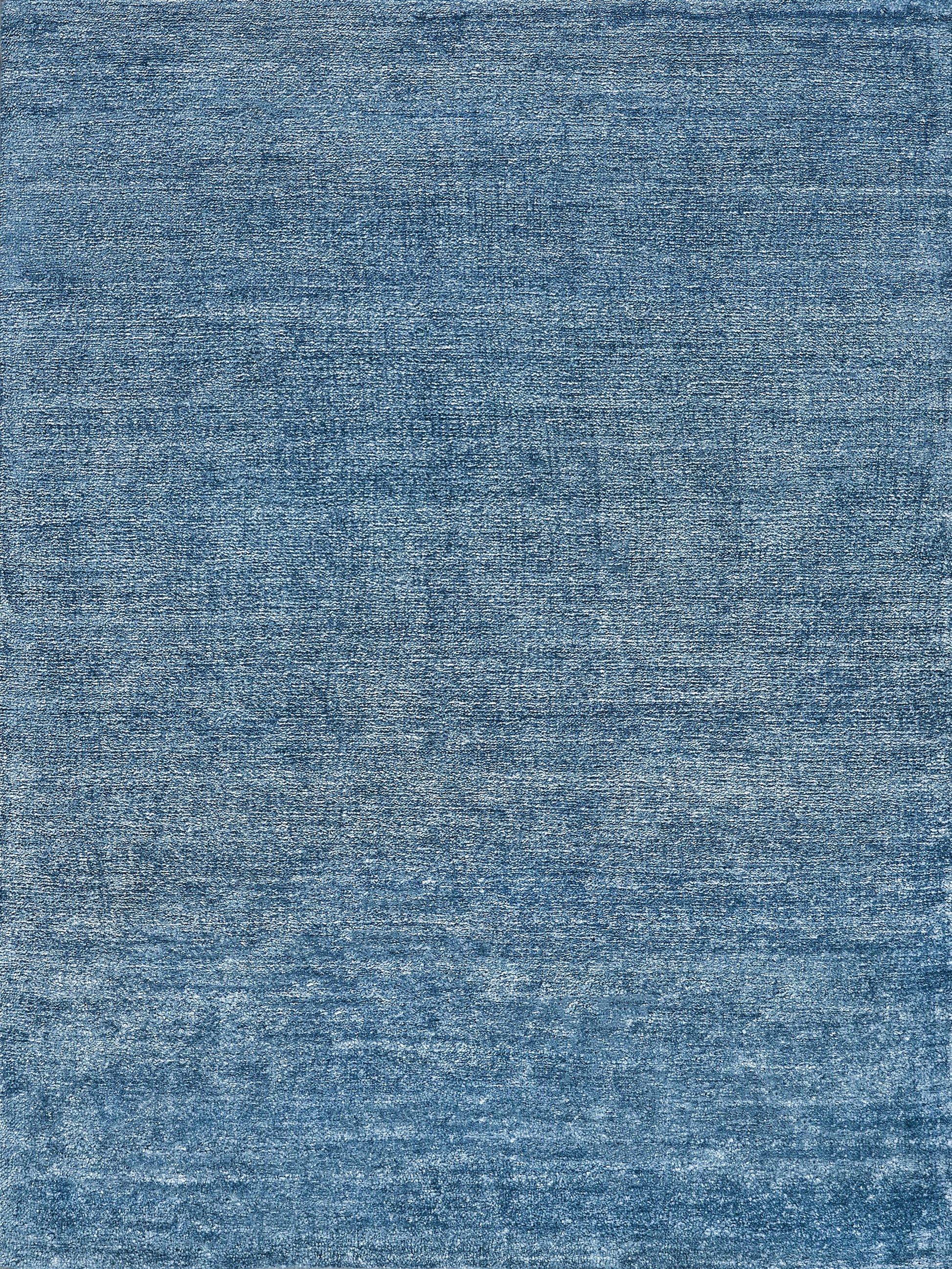Blue denim-look rug texture with a faded, worn wash and visible weave.