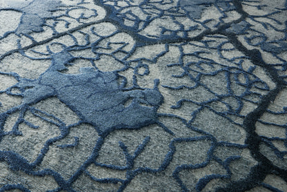 Blue and gray abstract area rug with dark blue branching lines and plush textured pattern.