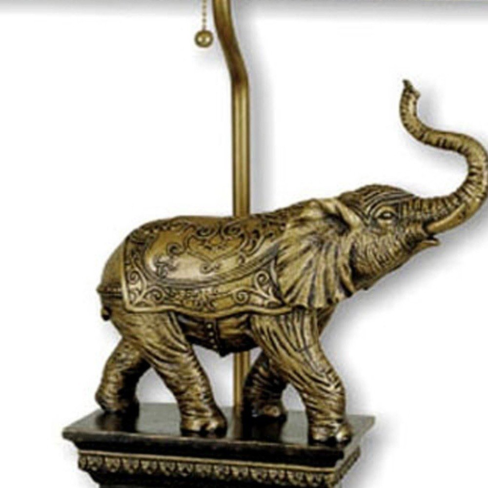 Antique elephant-shaped table lamp with an ornate base and lampshade.