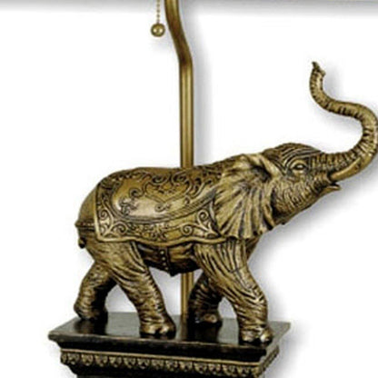 Antique elephant-shaped table lamp with an ornate base and lampshade.