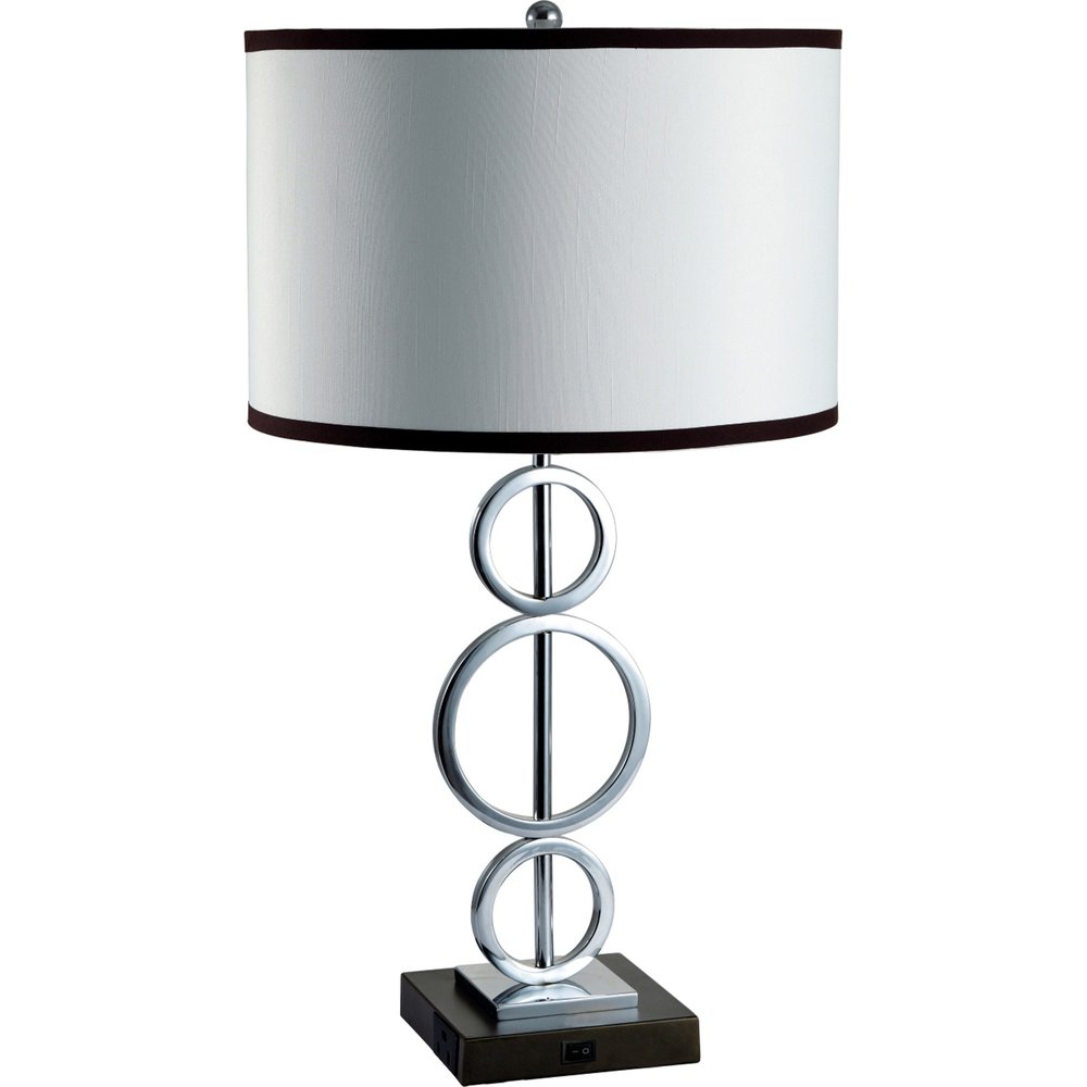 Modern table lamp with stacked chrome rings on a dark rectangular base and a white drum shade with dark trim.