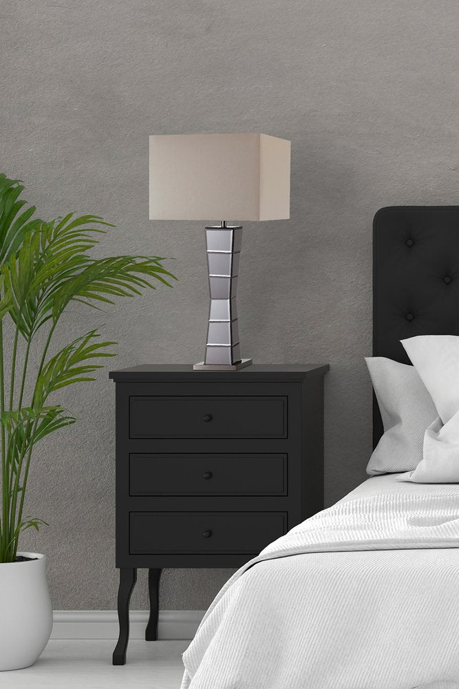 Black glass tower table lamp with beige fabric shade.