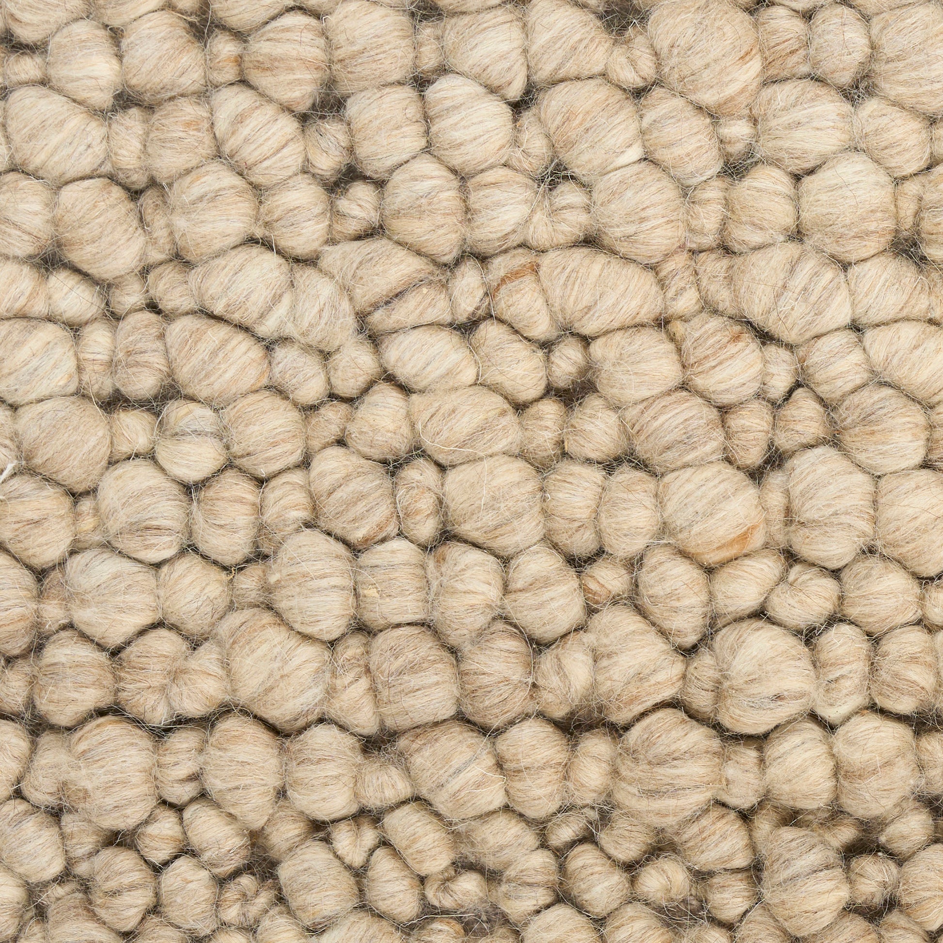 Natural beige boucle wool rug with chunky, rounded loops.