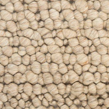 Natural beige boucle wool rug with chunky, rounded loops.