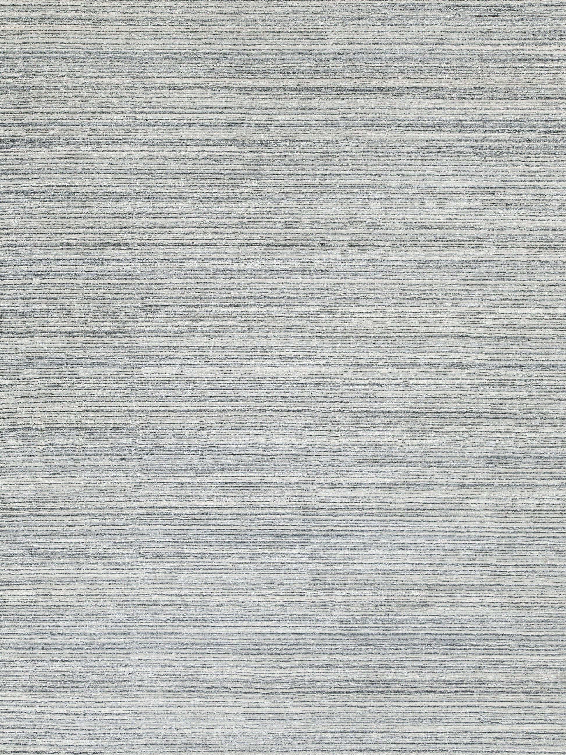 Light gray woven rug with subtle horizontal stripes; modern, soft-textured area rug.