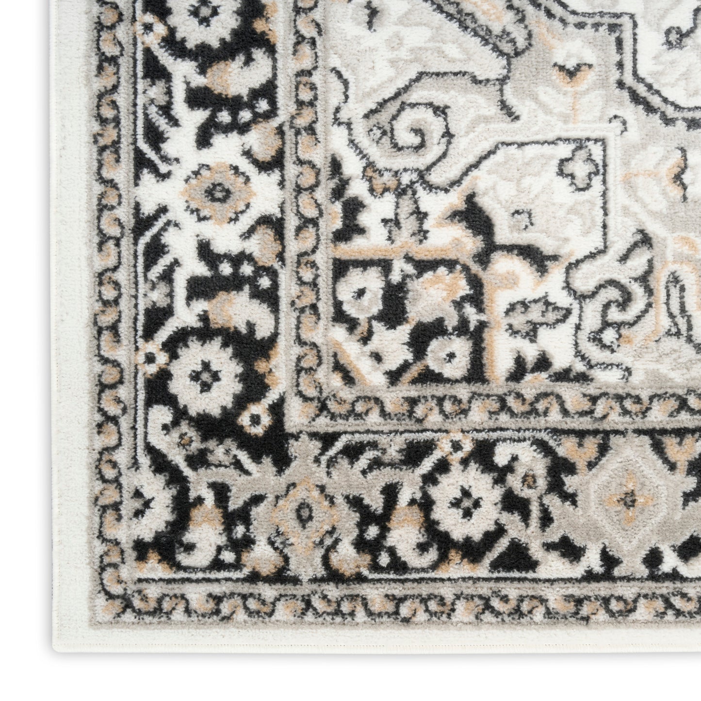 Close-up of an ornate beige, black and ivory oriental rug with floral border and intricate medallion pattern.