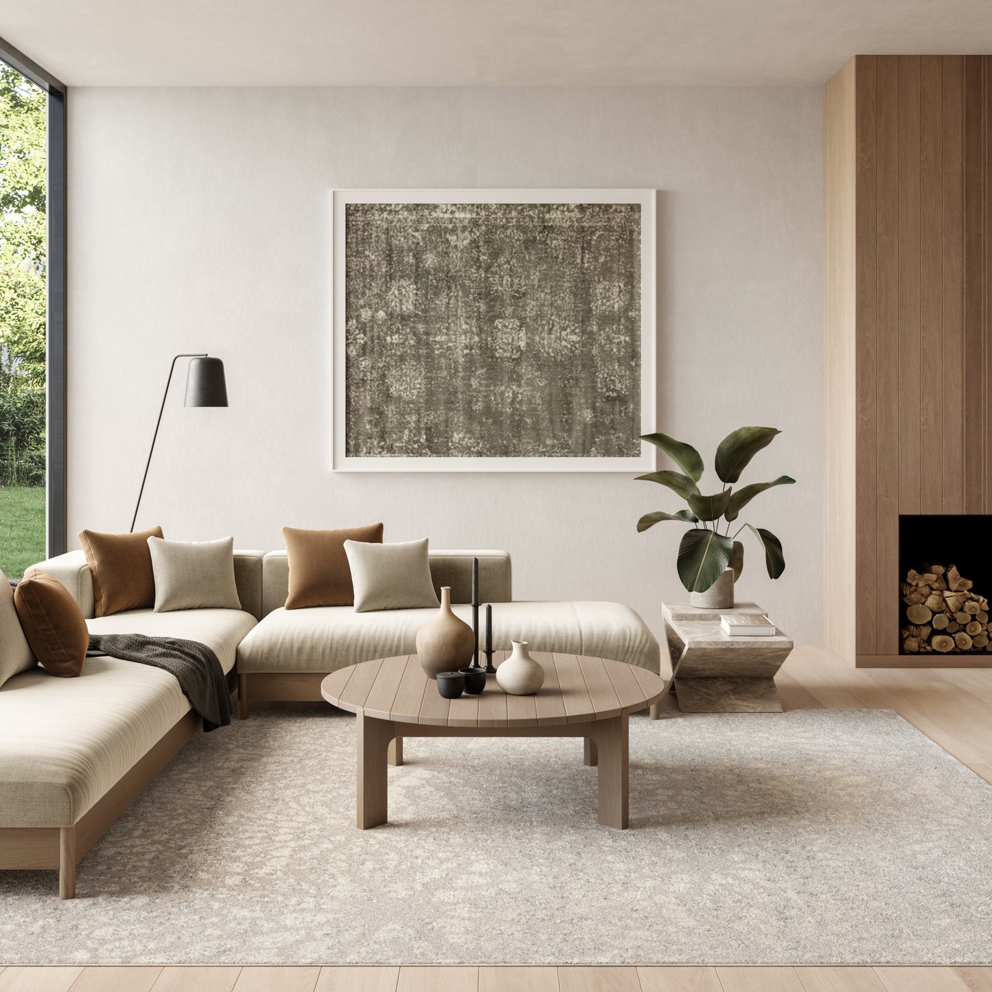 Neutral living room with beige sectional, round wood coffee table, black floor lamp, abstract art, plant, rug, fireplace.