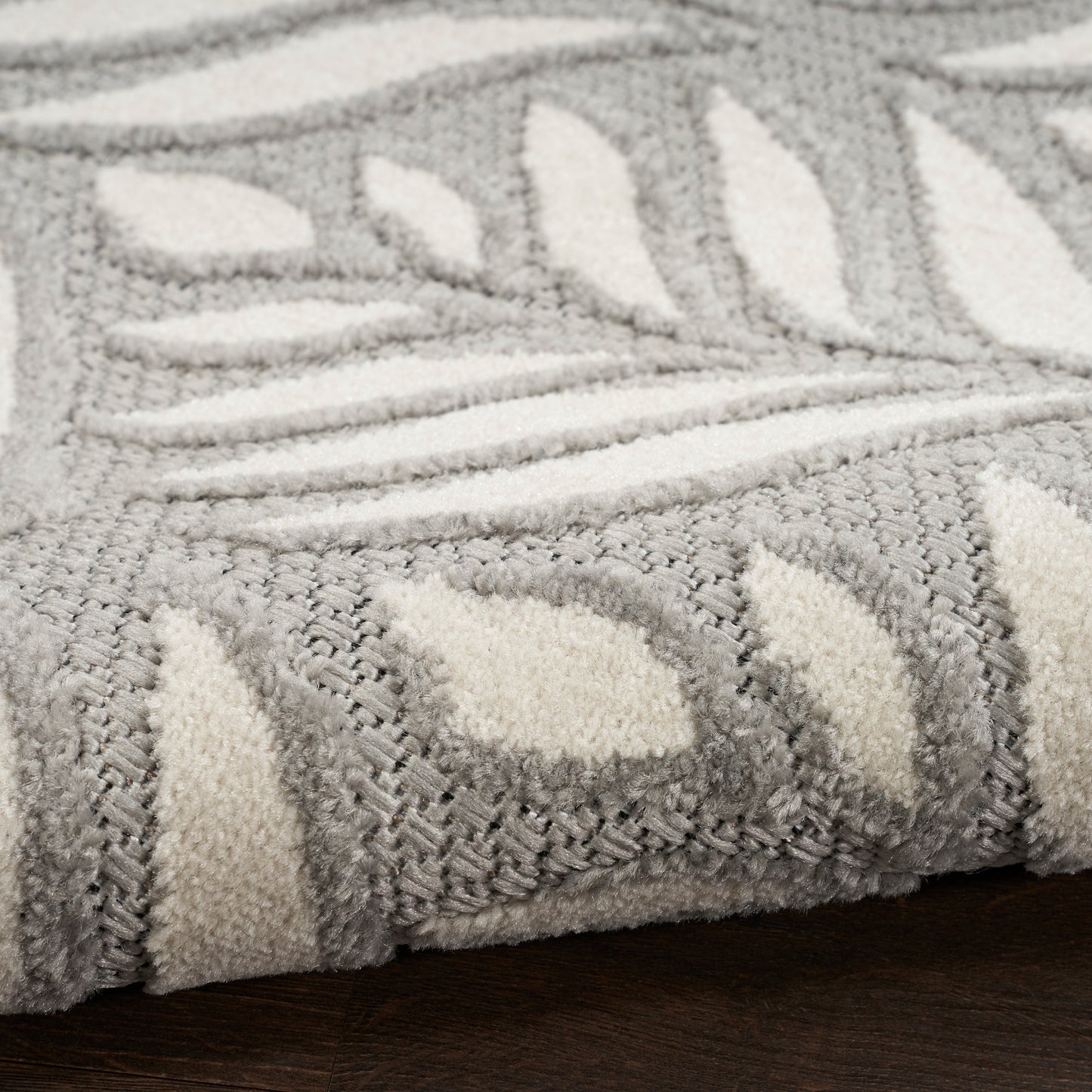 Gray & ivory plush rug (4' x 6') with leaf motif and woven border; soft, textured, ideal for living room.