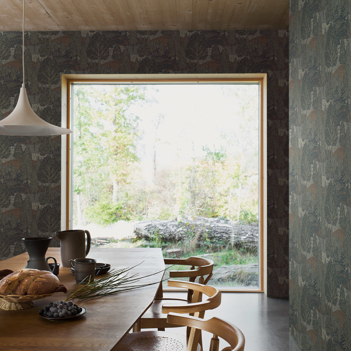 Dark forest leaf-pattern wallpaper featuring spruce motifs and greenery in natural greens and browns.