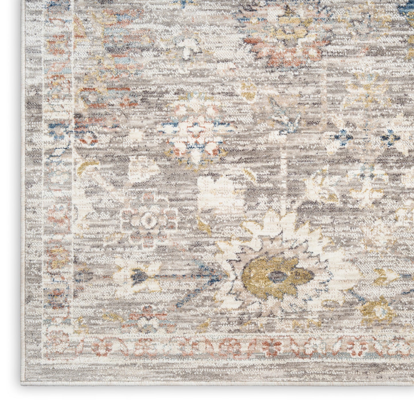 Distressed vintage floral area rug in beige-gray tones with ivory center, soft blue accents and sunflower motif.