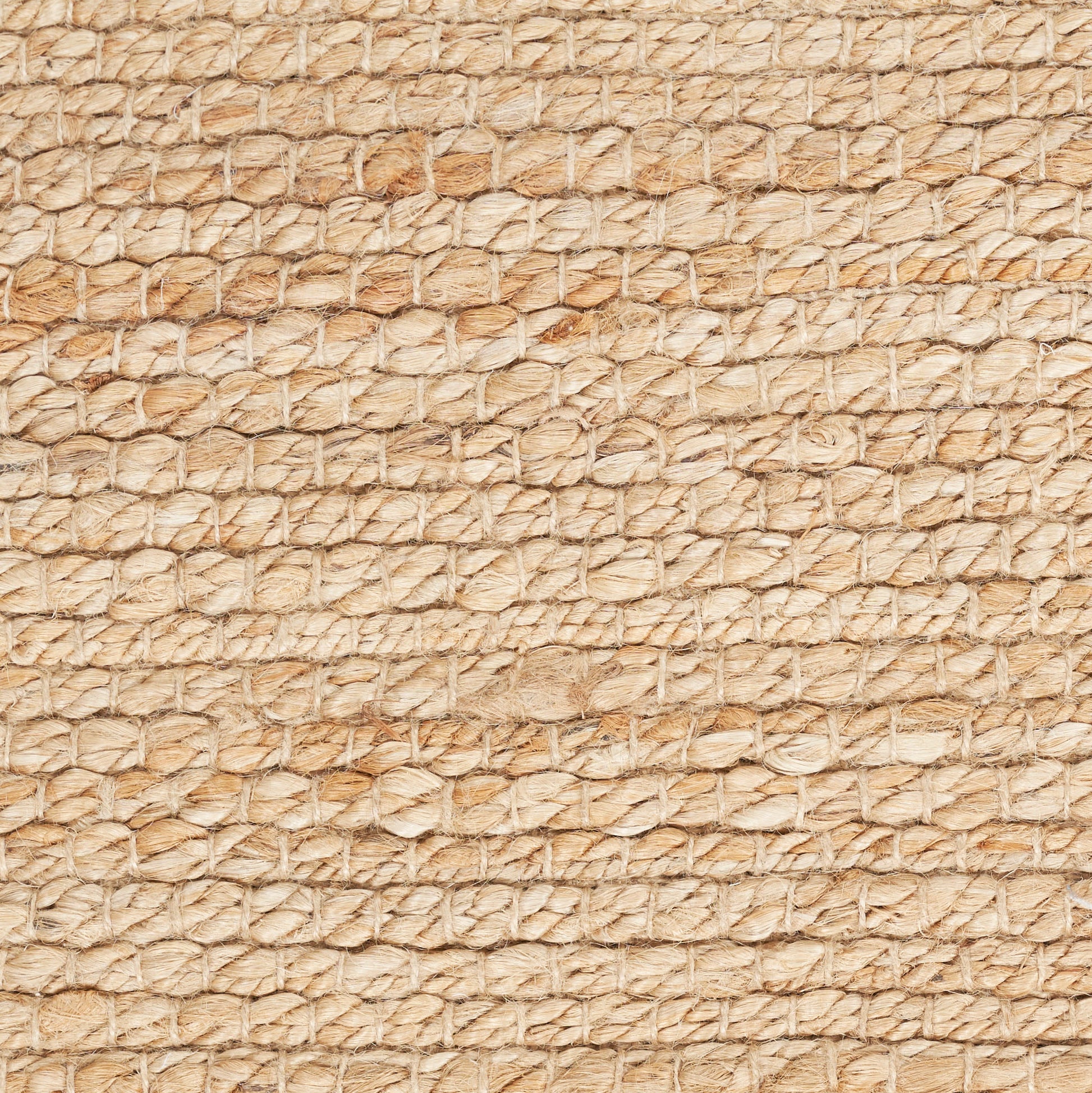 Beige natural fiber rug with coarse woven loops, rustic jute/sisal texture.