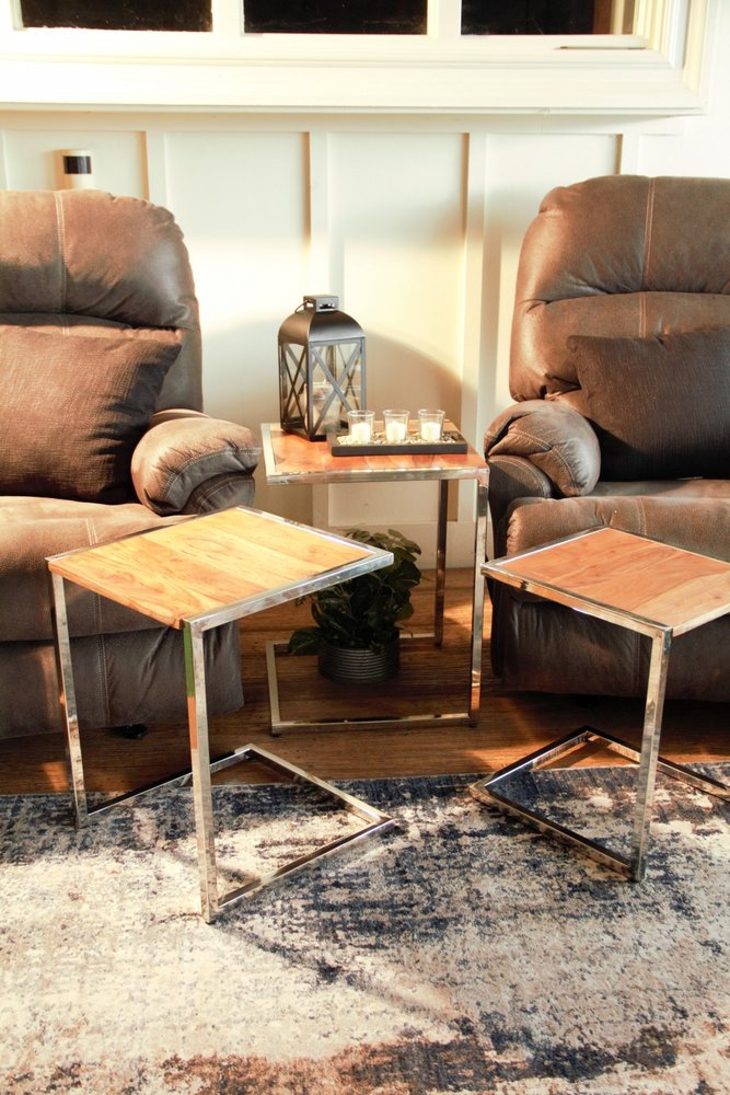 Set of three stylish wood and metal C-shaped nesting end tables.