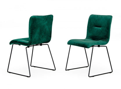 Set of two emerald green upholstered fabric dining side chairs with black metal sled legs.