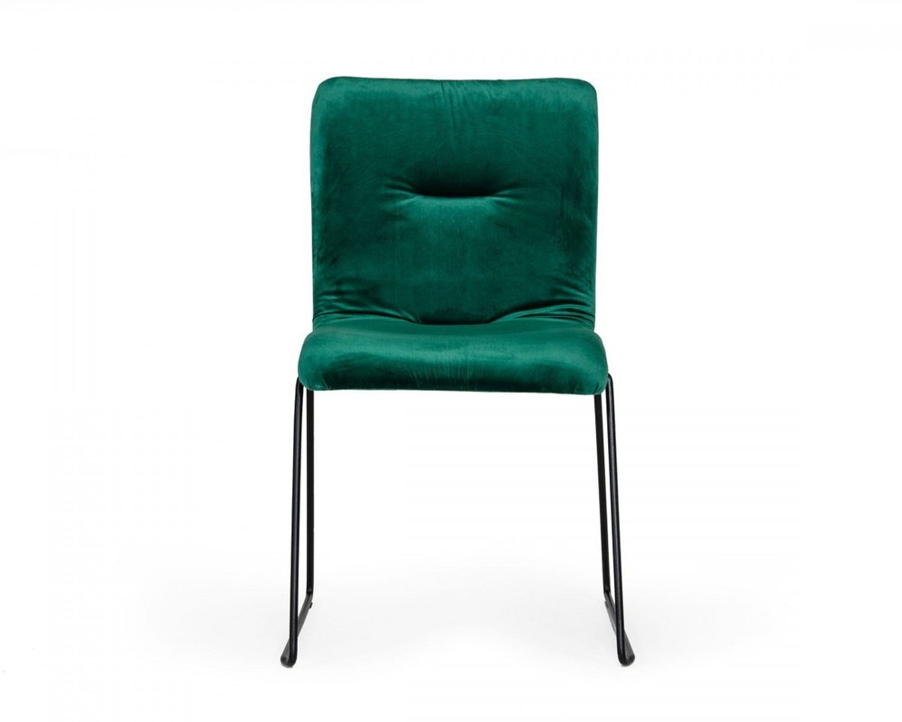 Set of two emerald green upholstered fabric dining side chairs with tufted backs and cushioned seats on black metal sled legs.