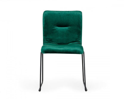 Set of two emerald green upholstered fabric dining side chairs with tufted backs and cushioned seats on black metal sled legs.