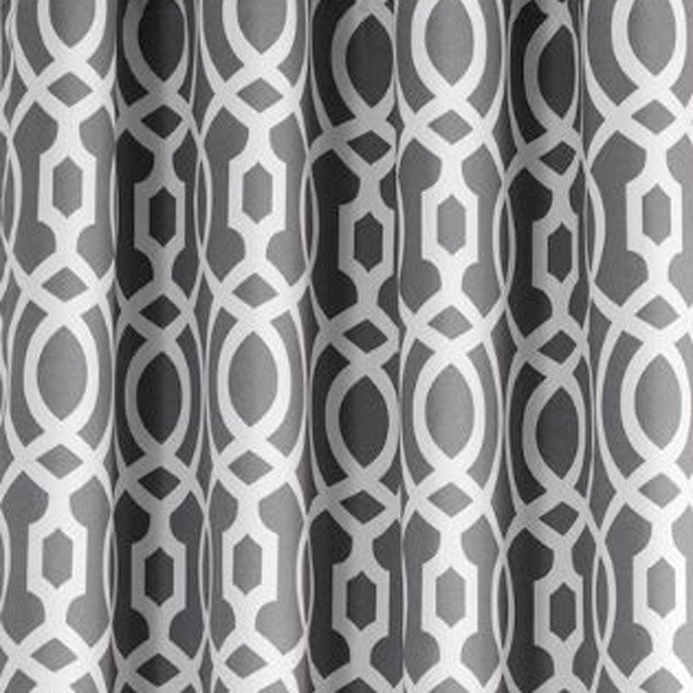 Grey curtains with a white interlocking geometric lattice of circles and hexagons.