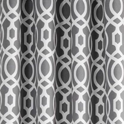 Grey curtains with a white interlocking geometric lattice of circles and hexagons.