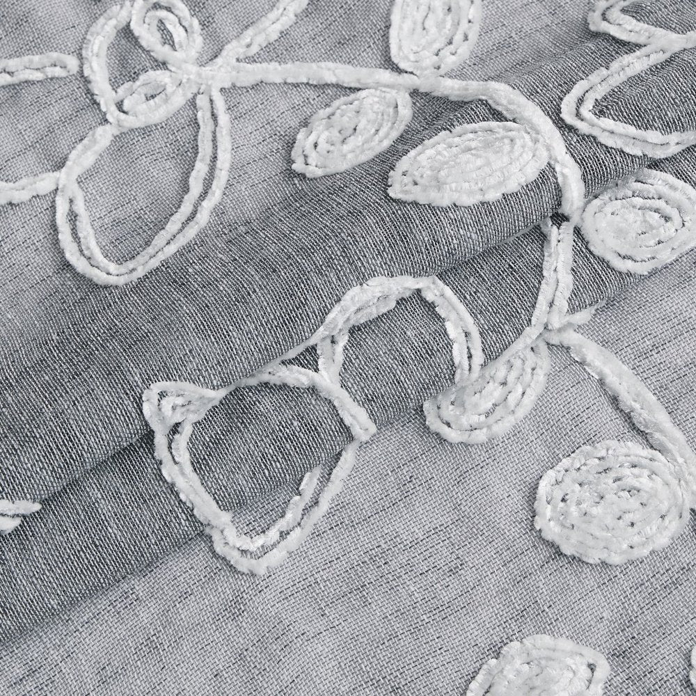 Two 96" silver floral embroidered window panels.