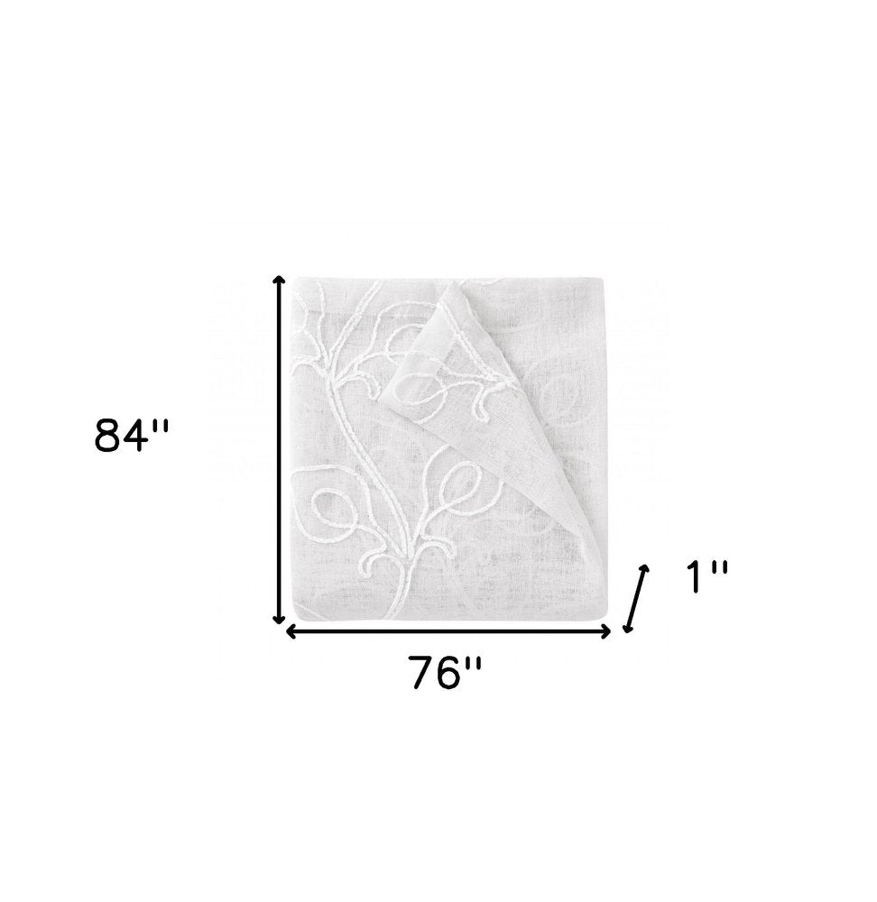 White oversized blanket with embossed vine motif, folded corner; 84x76 inches.