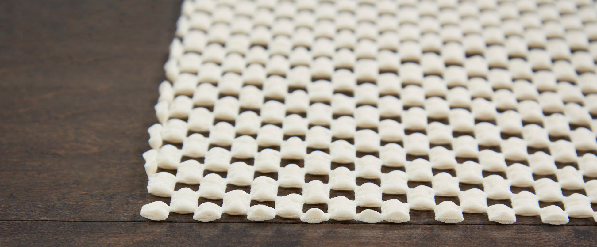 Cream rug with a square lattice pattern.