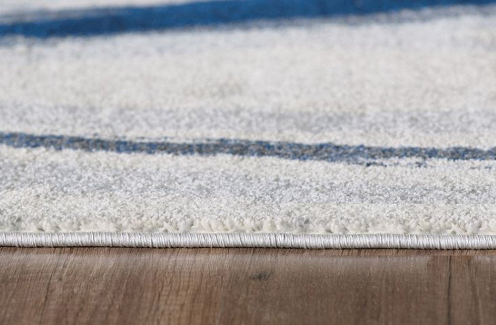 7' X 10' Ivory and Blue Abstract Area Rug