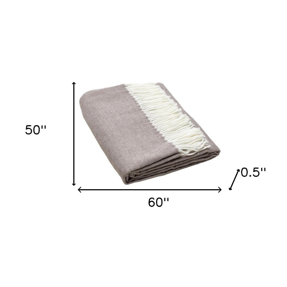 Soft taupe throw blanket with cream fringe, folded, 60" x 50" x 0.5" thick, cozy home decor.