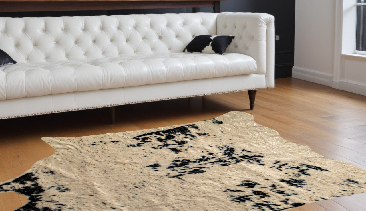 5' X 8' Off White Black and Gold Faux Cowhide Washable Area Rug