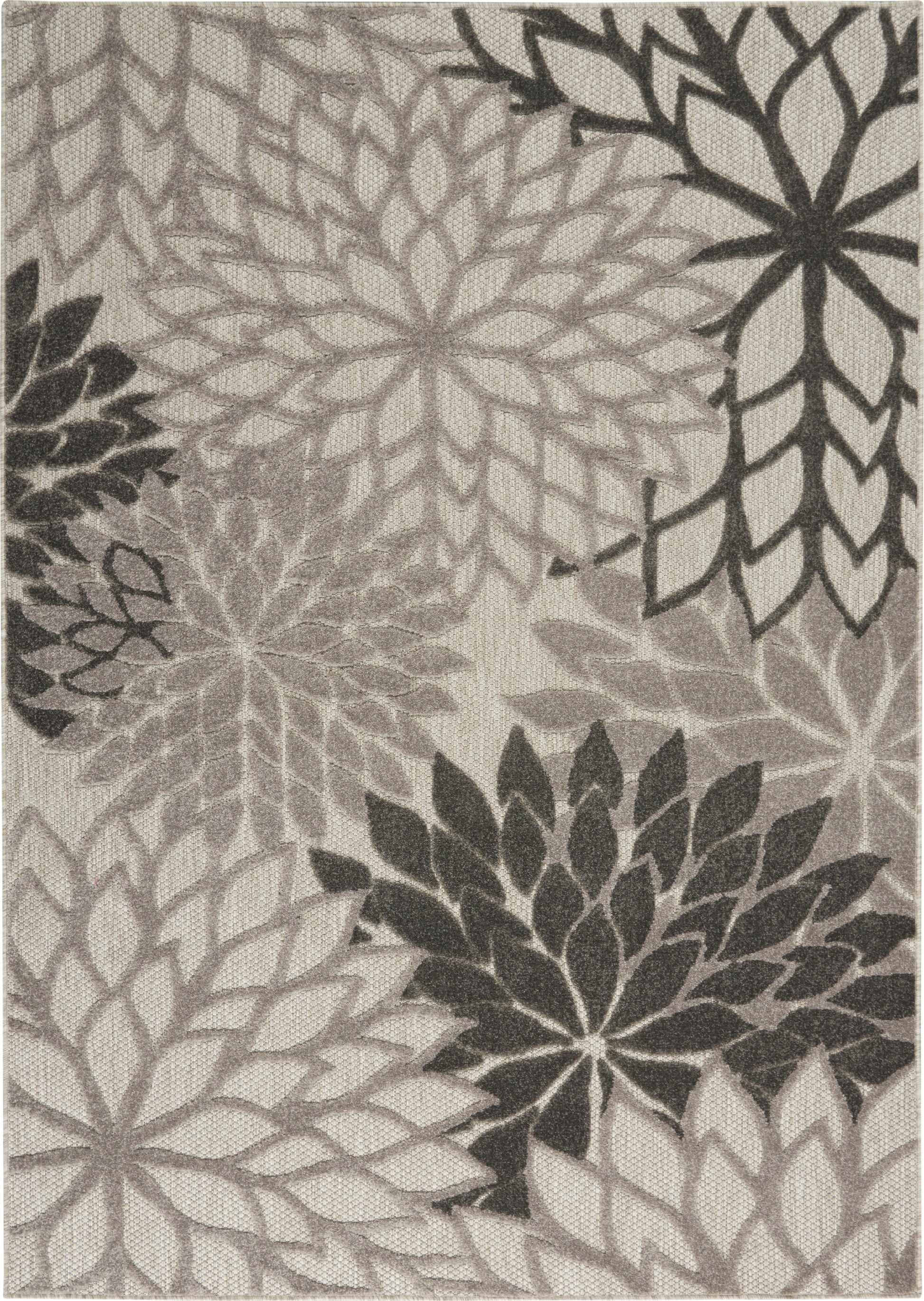 Gray-scale rug featuring oversized dahlia-like rosettes in layered petals on beige background