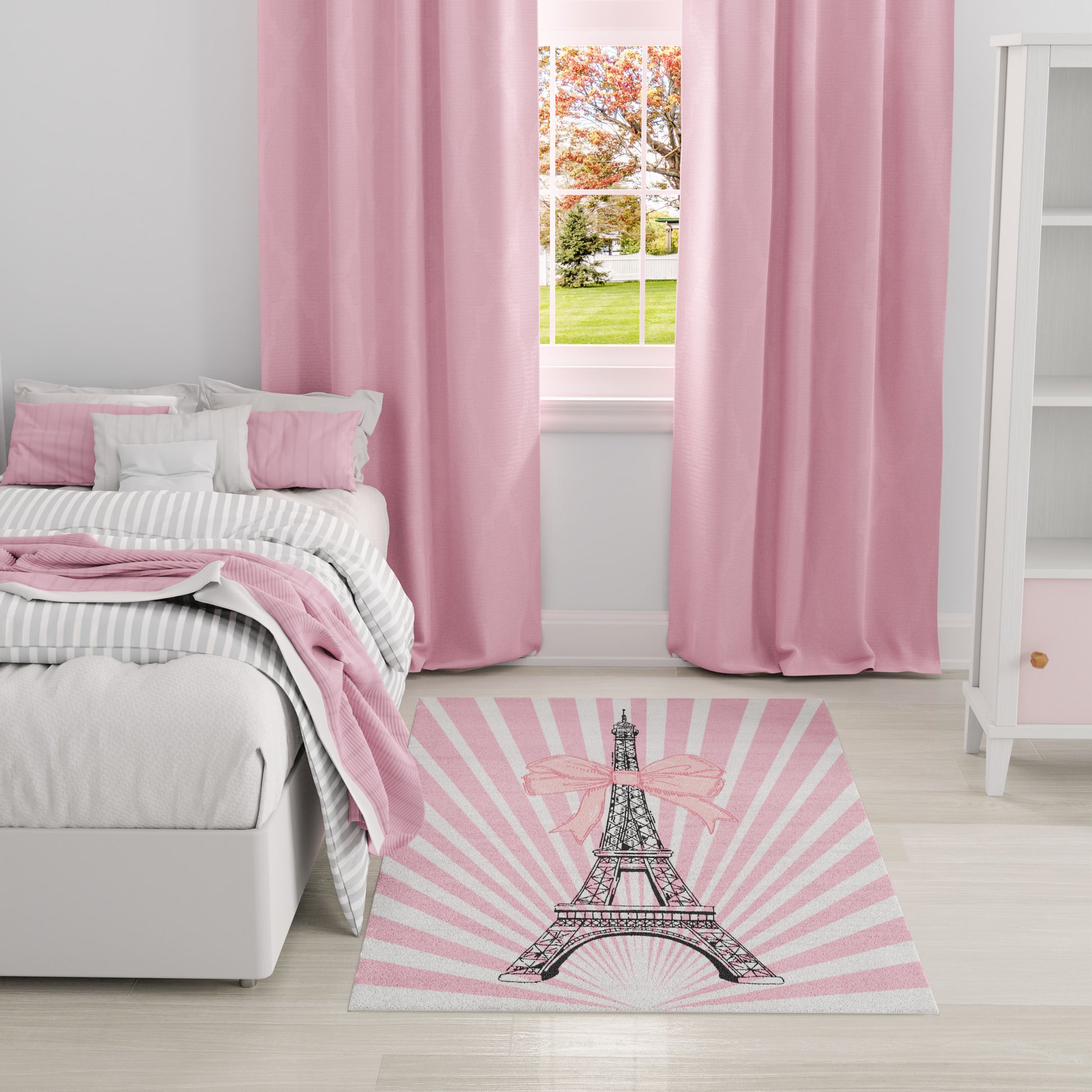 Pastel pink bedroom with striped gray bedding, pink throw, full-length pink curtains, and a pink Eiffel Tower rug with bow.