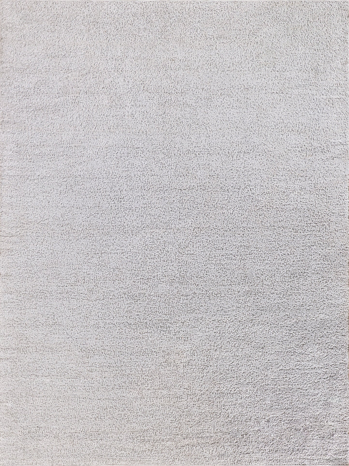 Rectangular light gray textured rug with a soft woven surface for modern living spaces.