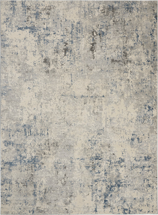 Abstract distressed area rug in blue, gray and cream tones with a weathered, mottled pattern.