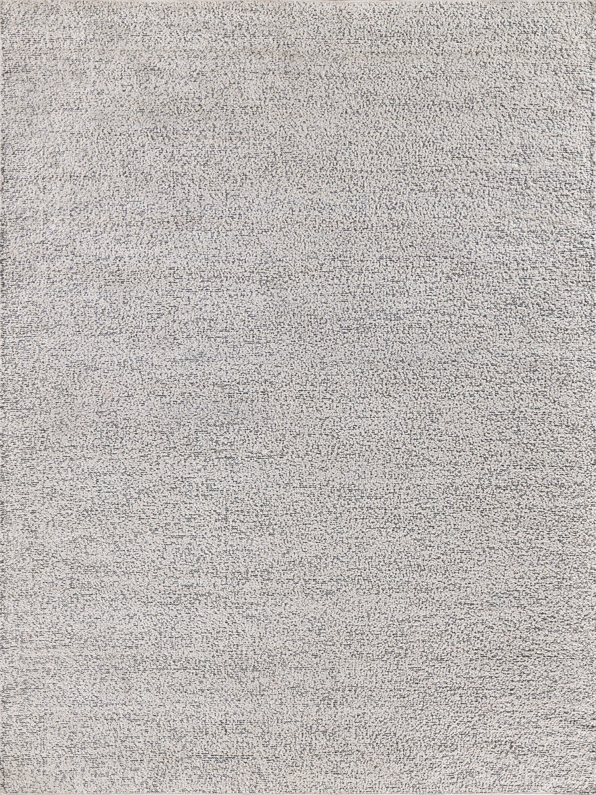 Light gray textured rug with subtle tonal variation and plush, low-pile surface.
