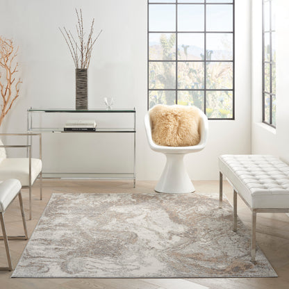 Bright white modern living room with a rug, glass & metal console, vase of branches, white tulip chair with sheepskin, and a tufted bench.