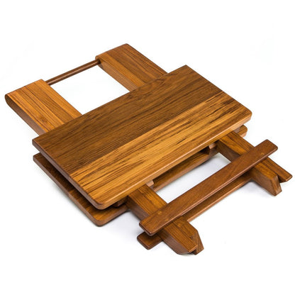 Wooden folding trivet with rectangular top and slatted legs in warm brown finish.