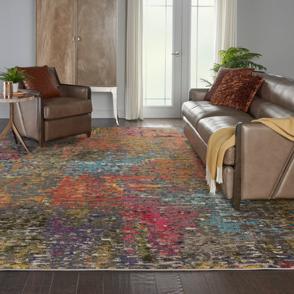 Vibrant multicolor distressed area rug over dark wood floor with brown leather sofa and chair, throw blanket.