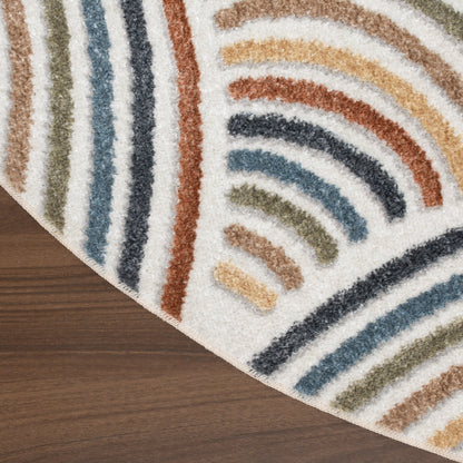 Round shag rug with multicolor curved stripe pattern on cream background, placed on wood floor.