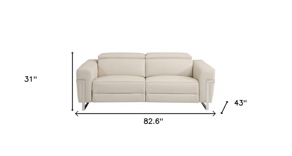 83" Beige Italian leather USB reclining sofa with silver legs.