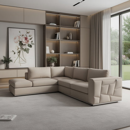 Beige modular sectional sofa with chaise in a modern living room, built-in bookshelf, warm lighting, and large windows.