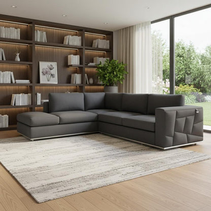 Charcoal gray L-shaped sectional with chaise, quilted side panel, low-profile modern sofa.