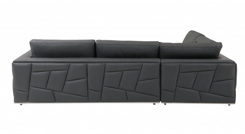 Dark gray leather sectional sofa with geometric stitched front panels, long chaise, low back cushions, metal legs.