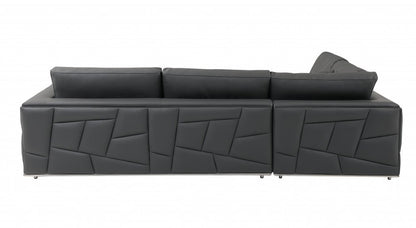 Dark gray leather sectional sofa with geometric stitched front panels, long chaise, low back cushions, metal legs.