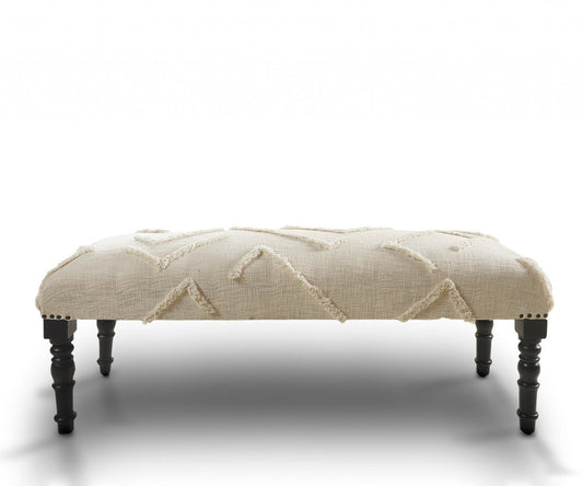 Cream and black cotton upholstered geometric bench, 47" long.