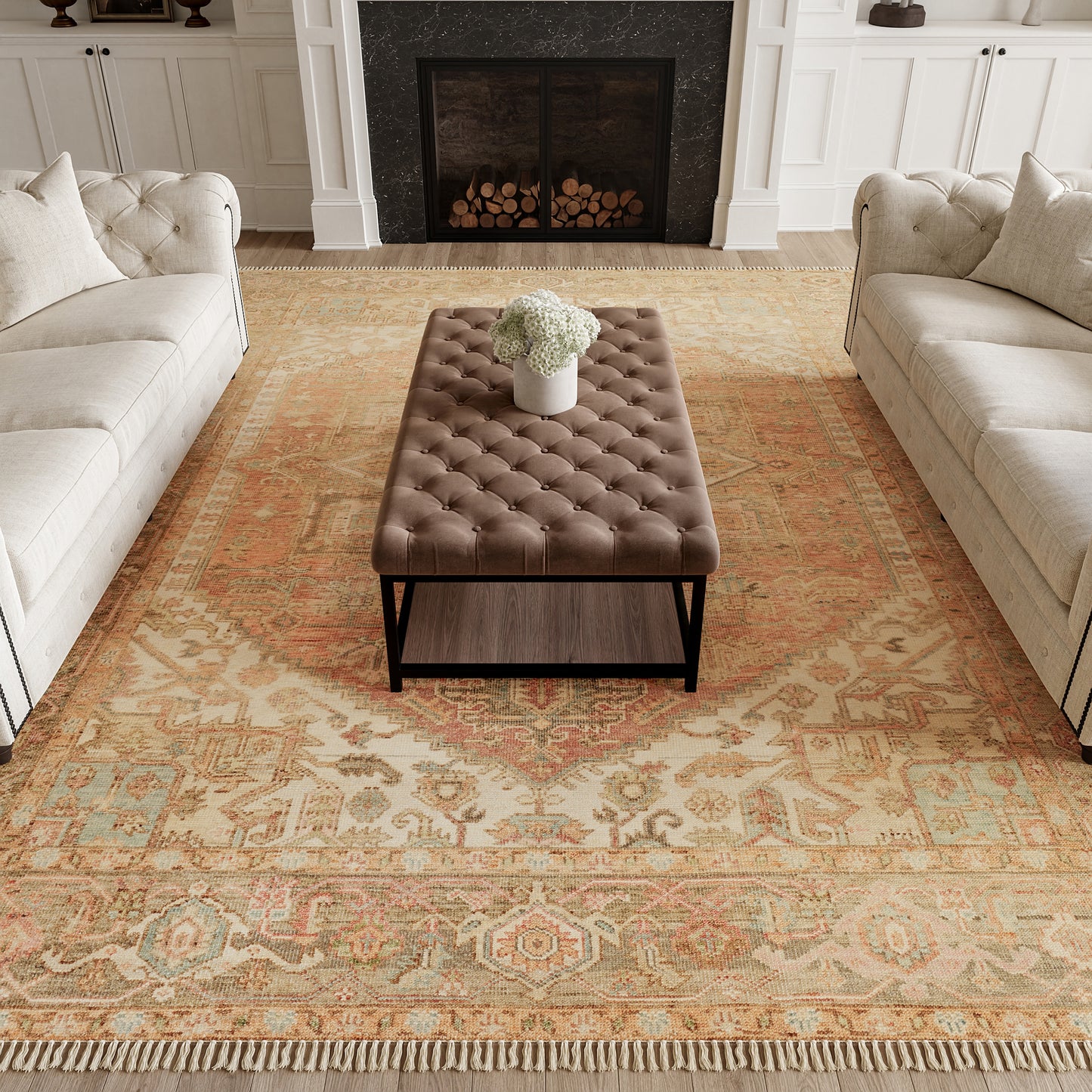 Brown tufted leather ottoman with black metal base and white flower vase, between cream sectionals on a beige oriental rug.