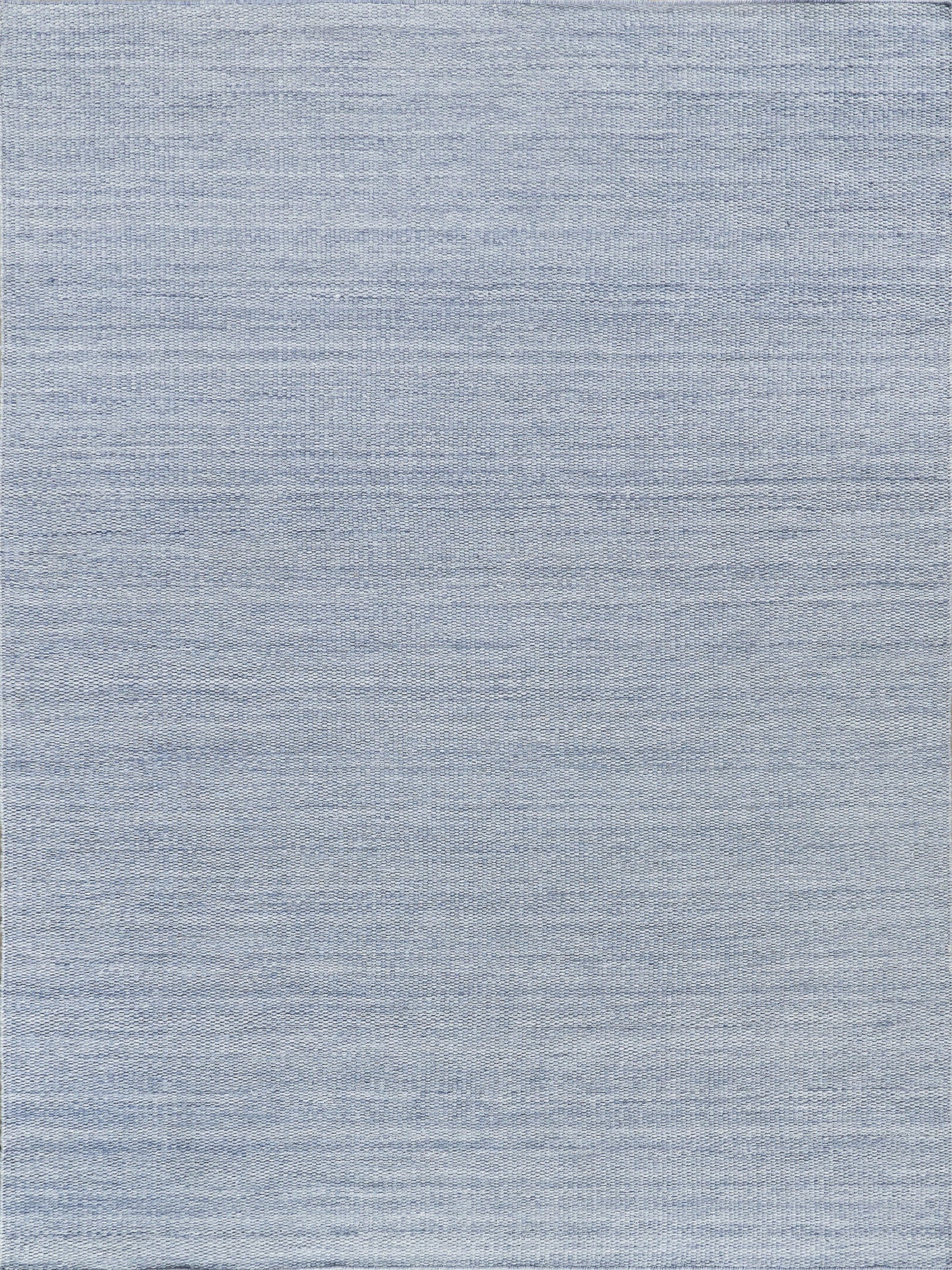 Light blue heathered rug texture close-up, chambray-style flat-weave.