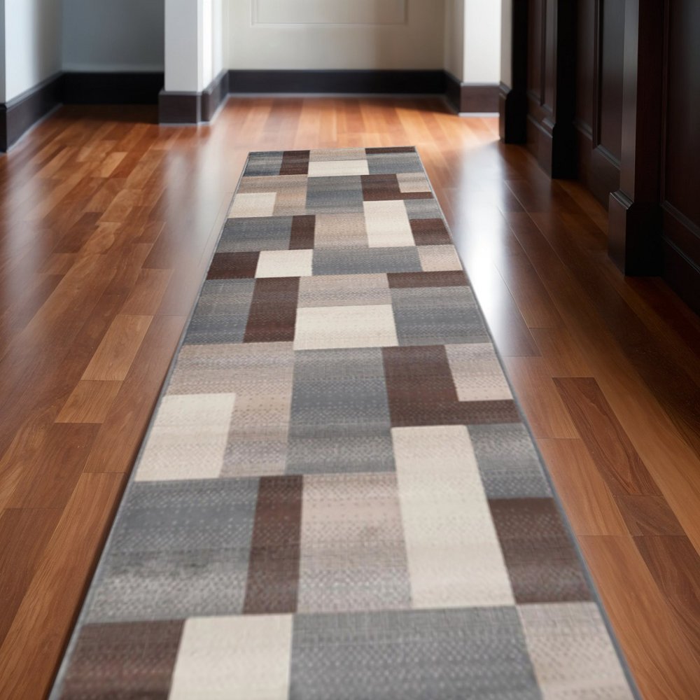 12' long runner rug with gray, tan and brown patchwork design.