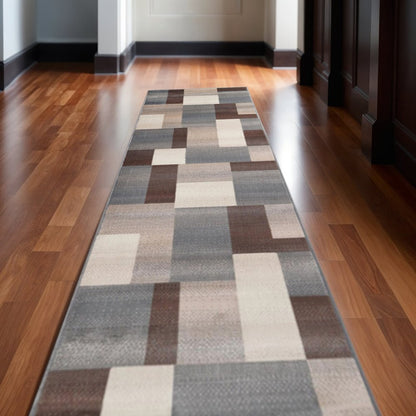12' long runner rug with gray, tan and brown patchwork design.