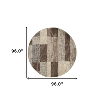 Round patchwork rug in beige, slate gray, and brown blocks, 96" diameter, cozy living room accessory.