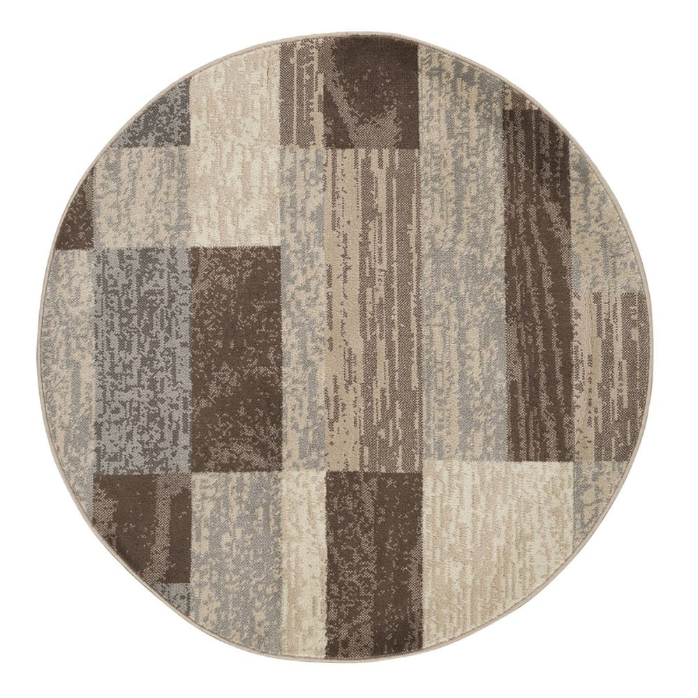 Circular rug with patchwork blocks in brown, taupe and beige tones; woven texture.