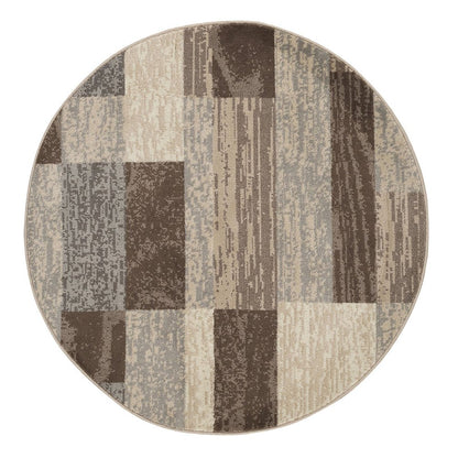 Circular rug with patchwork blocks in brown, taupe and beige tones; woven texture.